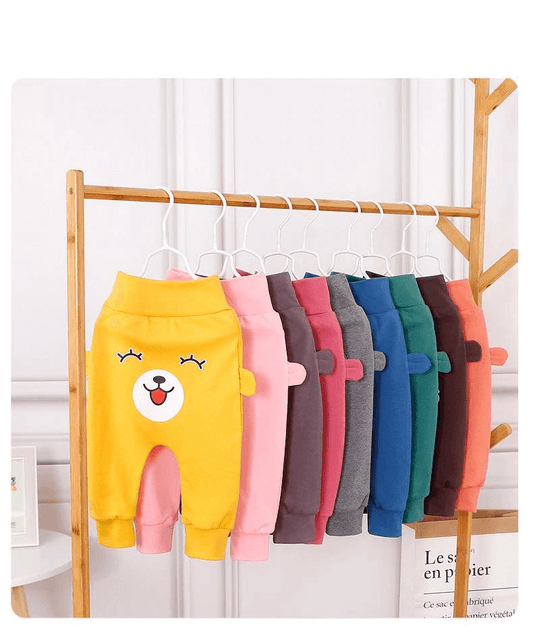 Stevvex baby pants with bear face and ears, assorted colors on a wooden rack on Tampa Home & Garden Store