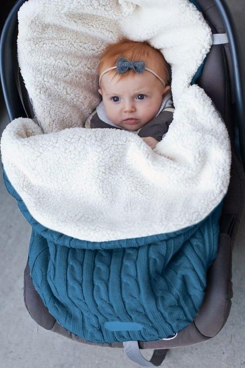 Warm baby blanket swaddle wrap by Stevvex; teal outer with cream sherpa lining in stroller on Tampa Home & Garden Store