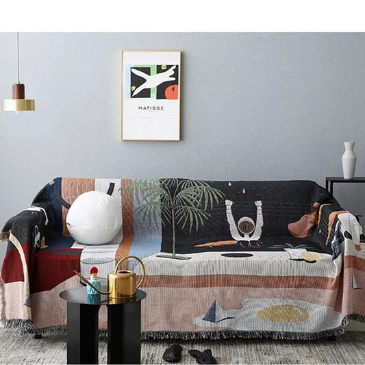 Nordic Throw Blanket with tropical print draped over a sofa on Tampa Home & Garden Store