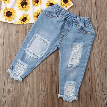 Light blue denim baby jeans with distressed patches and frayed hems on Tampa Home & Garden Store