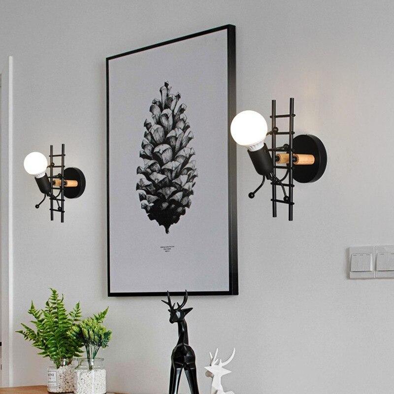 Stevvex ST10LM1584DEW wall sconces; pair black metal with globe bulbs beside botanical print on Tampa Home & Garden Store