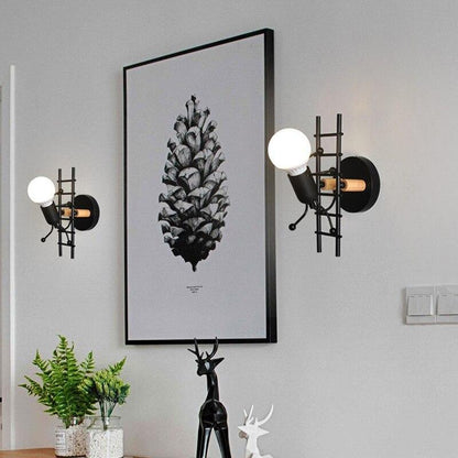 Stevvex ST10LM1584DEW wall sconces; pair black metal with globe bulbs beside botanical print on Tampa Home & Garden Store