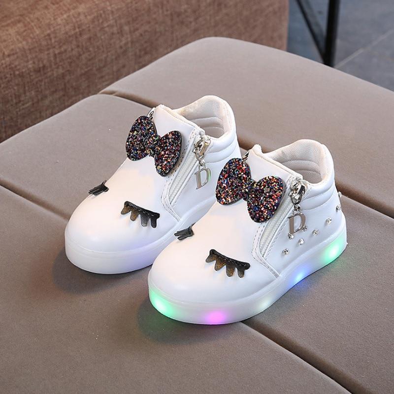 Stevvex white kids' glow sneakers with glitter bows, eyelash accents and rainbow LED lights pair on Tampa Home & Garden Store