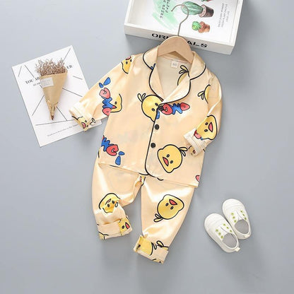 Stevvex kids satin pajama set with cartoon yellow duck print, cream top and pants on Tampa Home & Garden Store