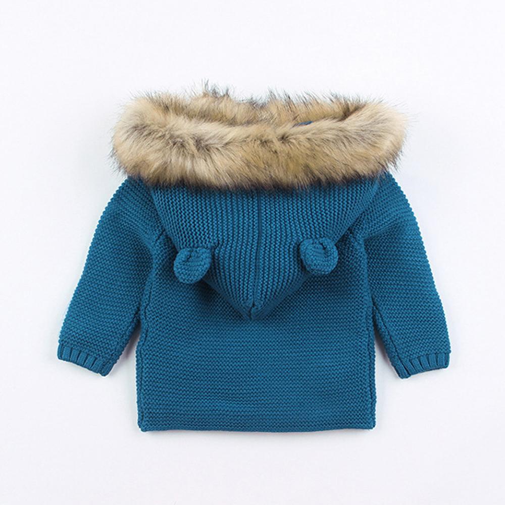 Stevvex blue knit hooded baby coat with fur-trimmed hood and twin pom pom accents back view on Tampa Home & Garden Store