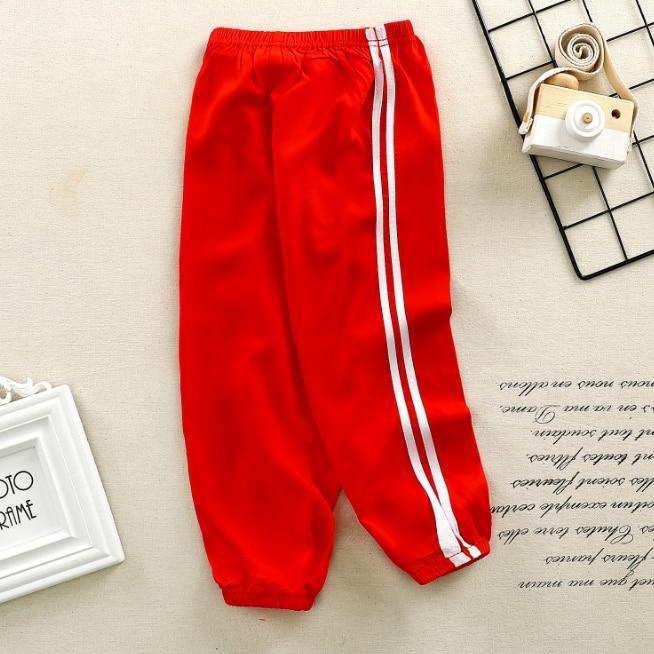 Kids sports pants Stevvex red with white stripes, elastic waistband and cuffed ankles on Tampa Home & Garden Store