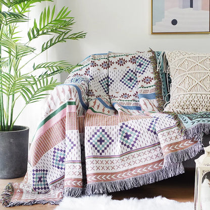 DecorBites Knitted Nordic Plaid Blanket draped over sofa with fringed edges and pattern on Tampa Home & Garden Store