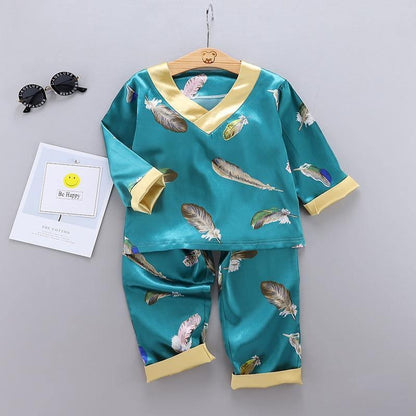 Kids satin pajamas set teal feather print with gold collar top and pants Stevvex on hanger on Tampa Home & Garden Store