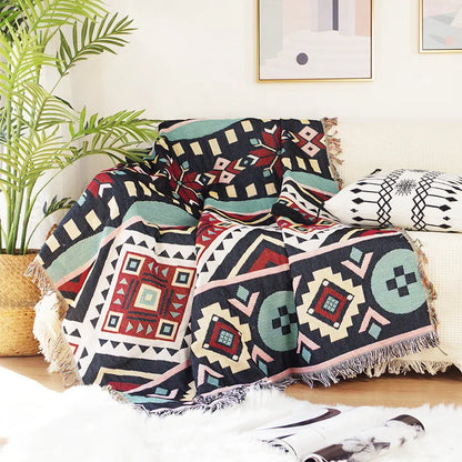 DecorBites™ Knitted Nordic Plaid Blanket draped over sofa with fringe on Tampa Home & Garden Store