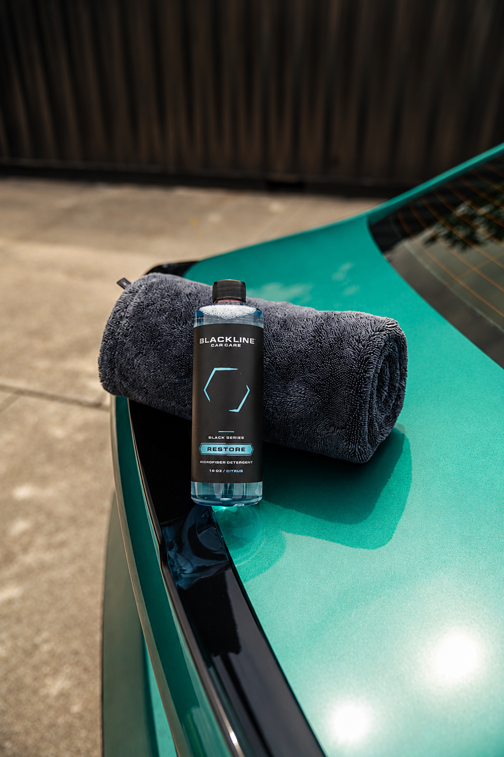BLACKLINE RESTORE Microfiber Detergent bottle on dark gray towel atop teal car hood on Tampa Home & Garden Store