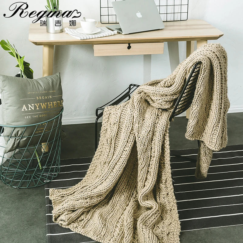 DecorBites Khaki Beige Chunky Knit Wool Blanket draped over a black chair in home office on Tampa Home & Garden Store