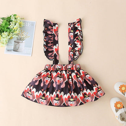 Newborn romper suspender dress set in red black and white floral print with ruffled straps on Tampa Home & Garden Store