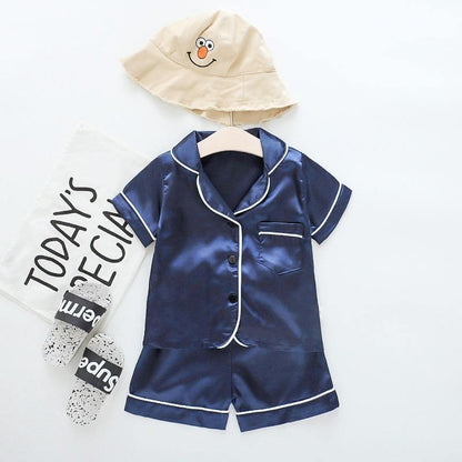 Stevvex navy ice silk satin kids pajama set with white piping (top + shorts) and beige cartoon hat on Tampa Home & Garden Store