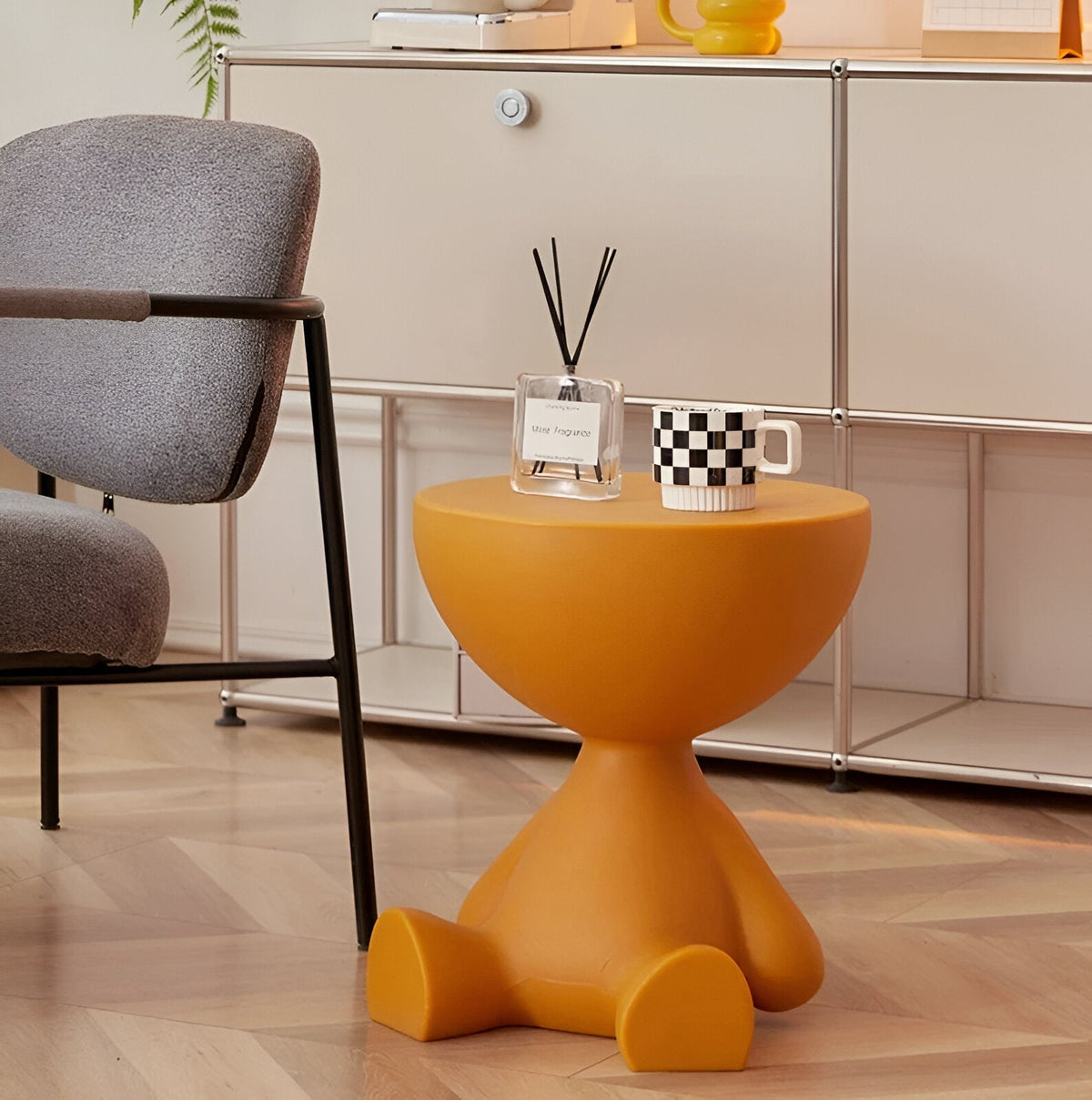 Round orange Moktan Sabai coffee table with diffuser bottle and black-and-white checkered mug on Tampa Home & Garden Store