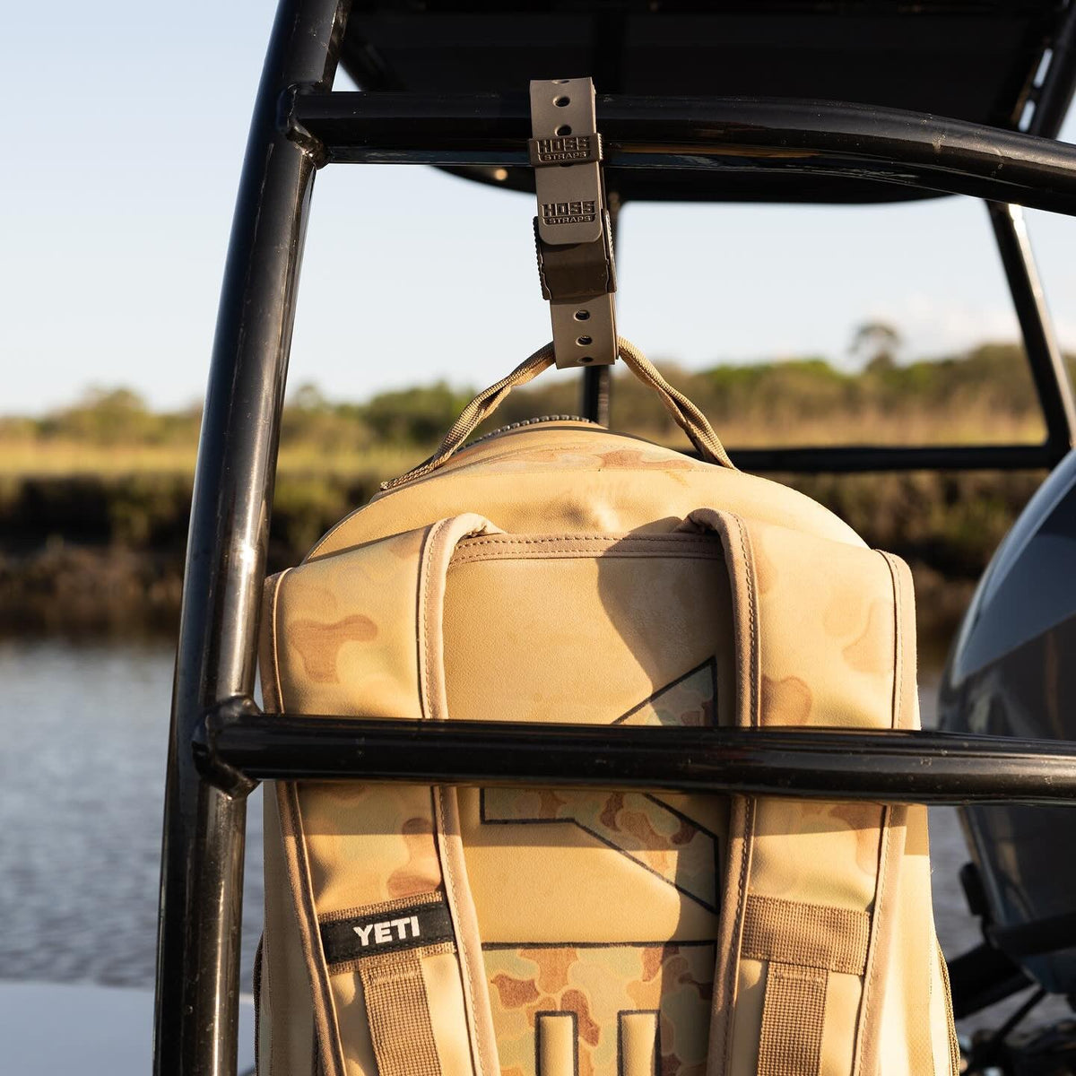 Hoss Straps 24-Inch gear strap securing tan camo backpack with visible buckle on a boat frame on Tampa Home & Garden Store