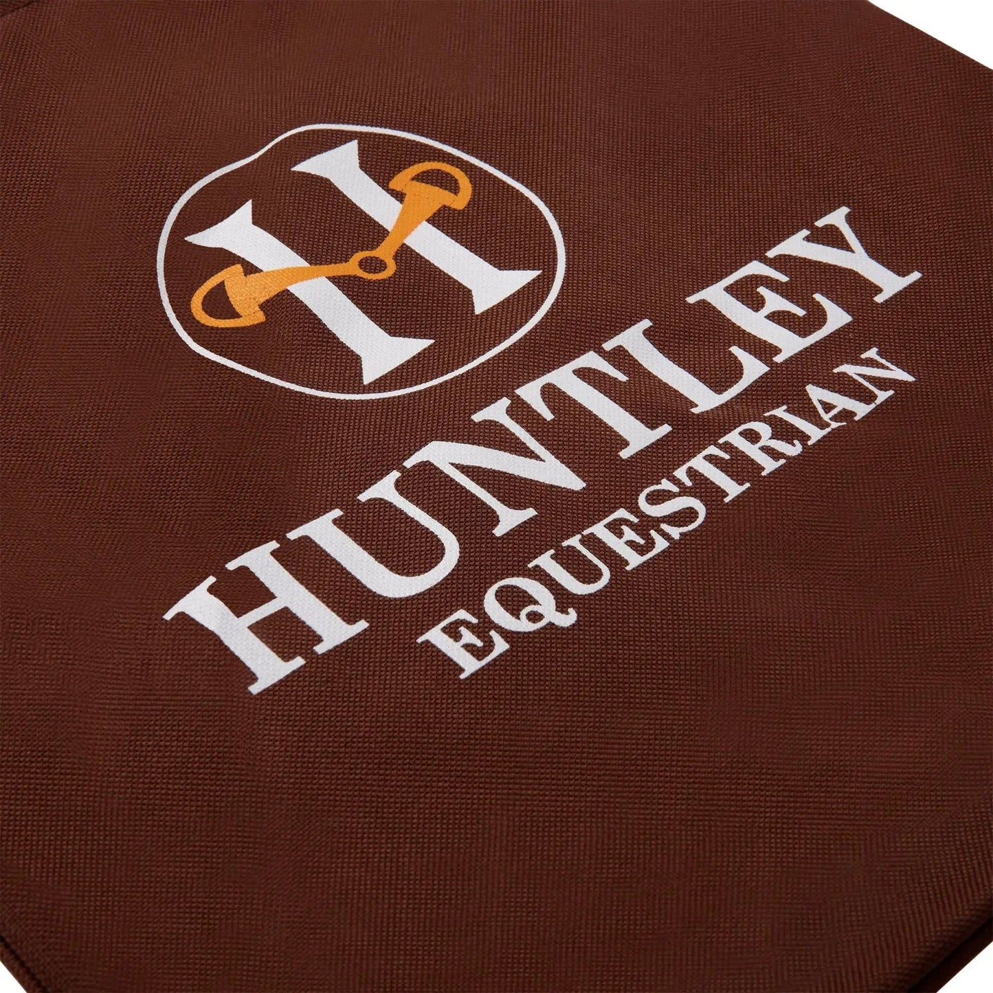Huntley Equestrian Tote Bag with white logo and orange stirrup on brown textile on Tampa Home & Garden Store