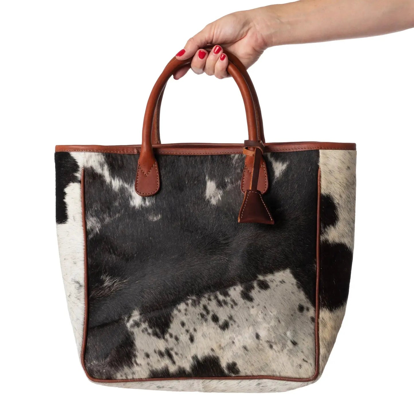 Huntley Equestrian hair-on-hide cow leather tote with tan leather trim and handles on Tampa Home & Garden Store