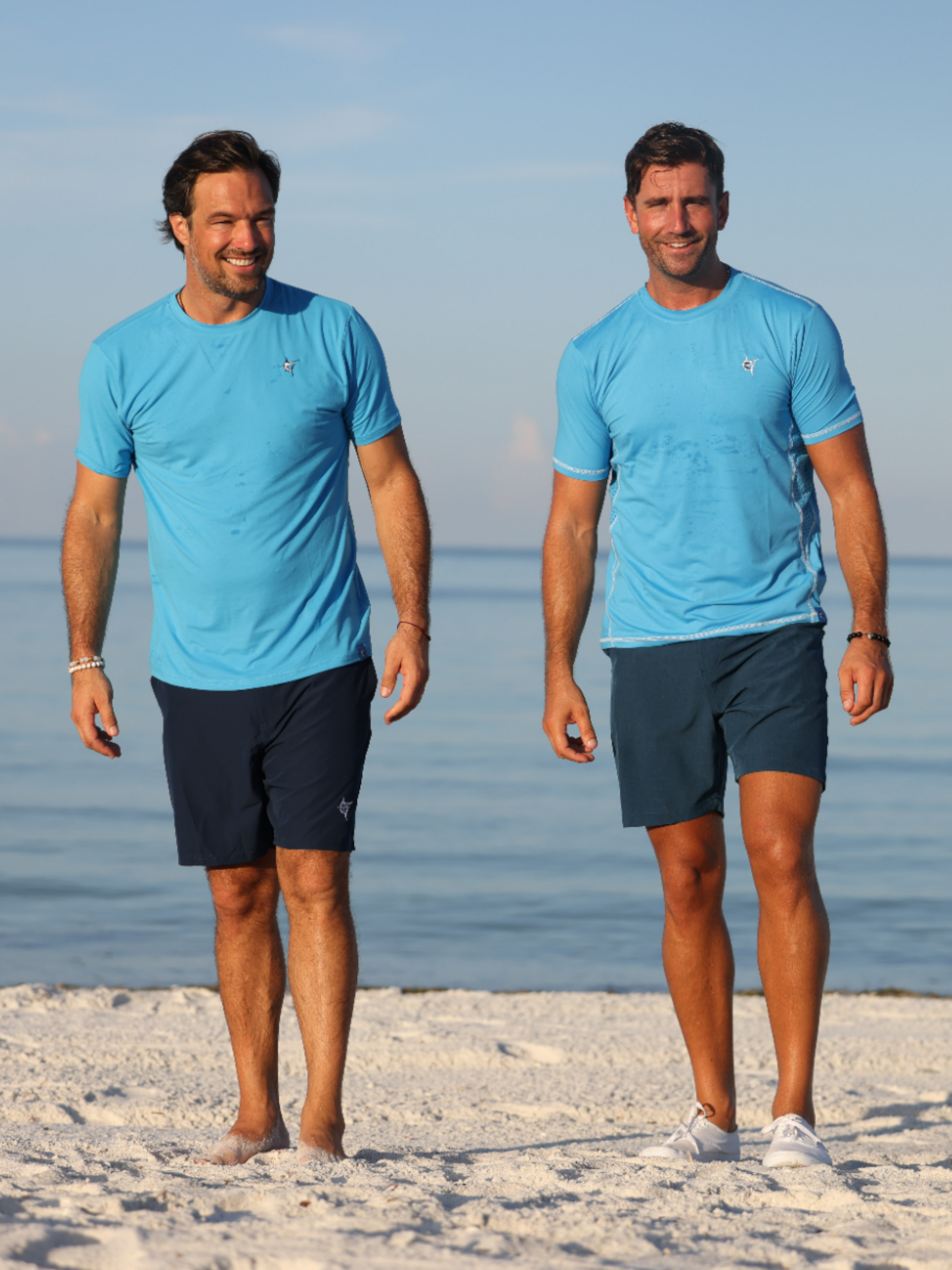 Grander Short Sleeve Performance Tee light blue with White Water Life logo, men on beach on Tampa Home & Garden Store