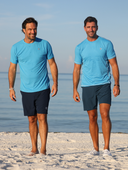 Grander Short Sleeve Performance Tee light blue with White Water Life logo, men on beach on Tampa Home & Garden Store