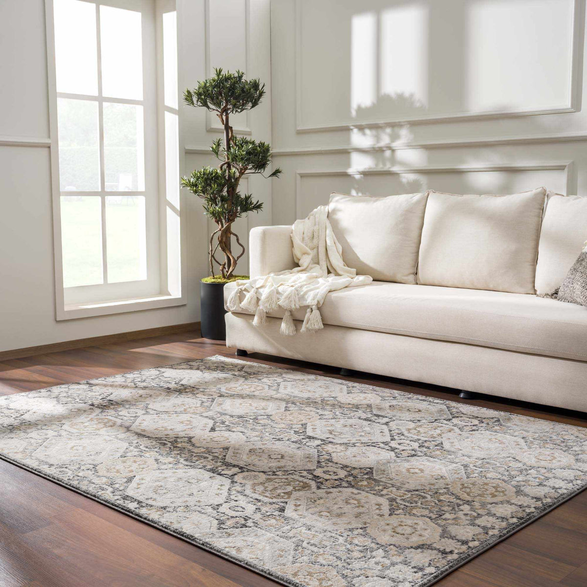 Minoa Area Rug by Boutique Rugs, cream with gray distressed pattern, in a bright living room on Tampa Home & Garden Store