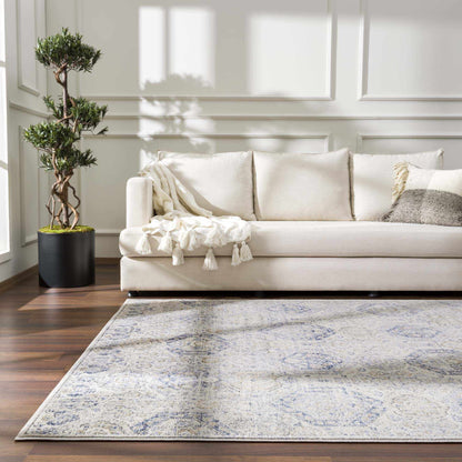 Parkerfield Cream & Blue Area Rug by Boutique Rugs with cream and blue pattern under beige sofa on Tampa Home & Garden Store