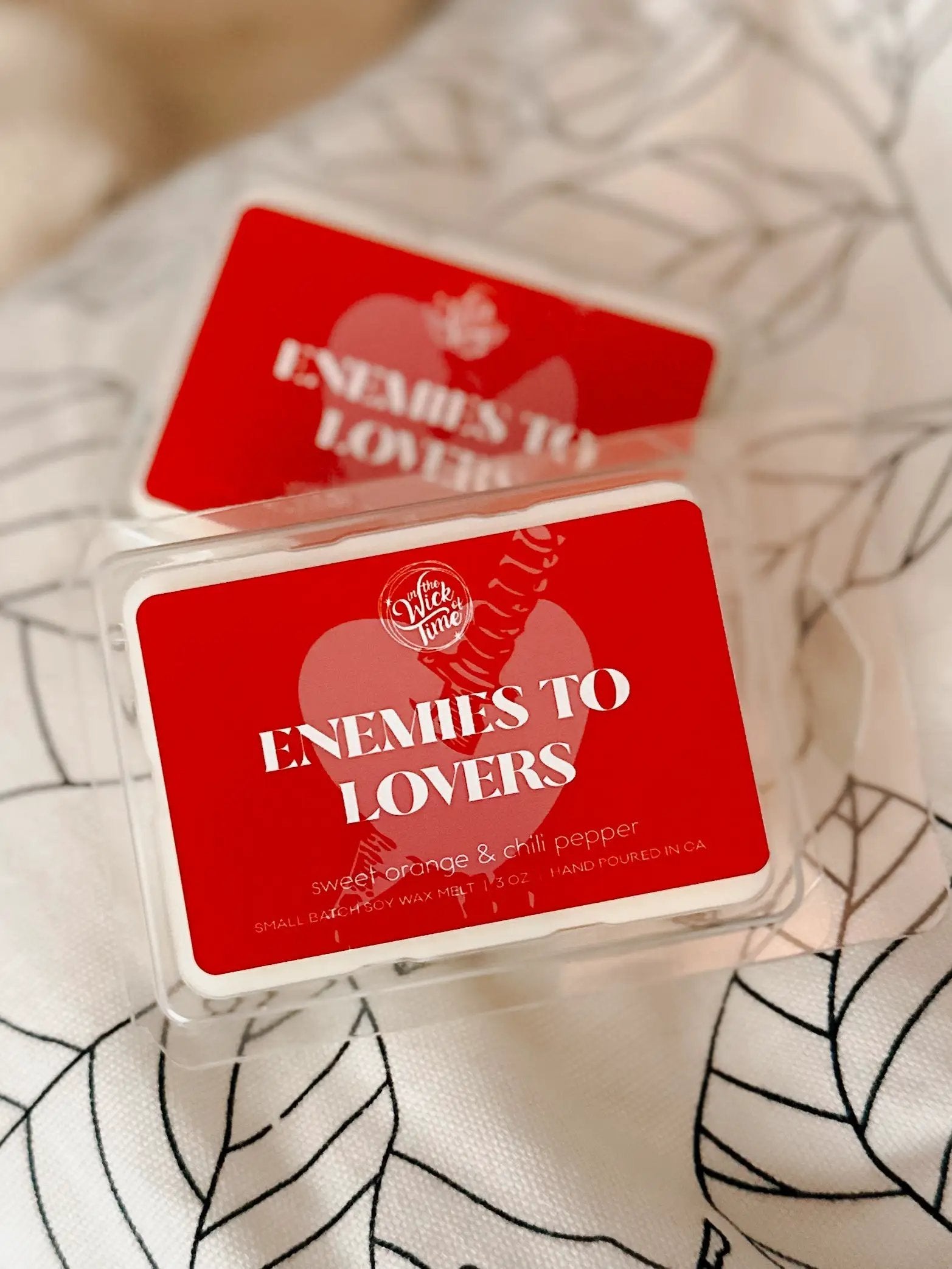 Enemies to Lovers Wax Melt red packaging with heart logo In the Wick of Time; orange scent on Tampa Home & Garden Store