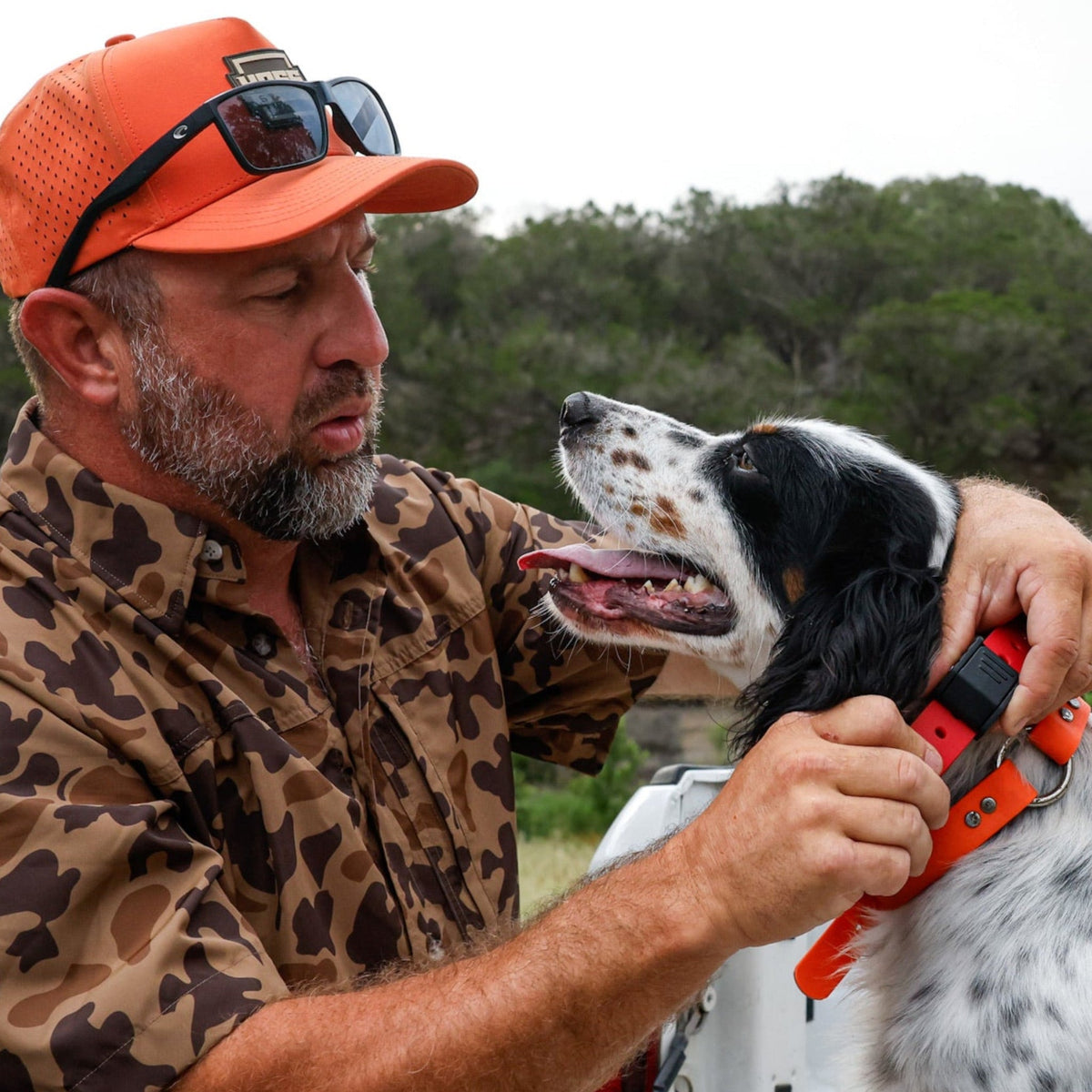 PRO SERIES FIELD COLLAR by Hoss Straps, bright orange hunting dog collar being held by a man on Tampa Home & Garden Store