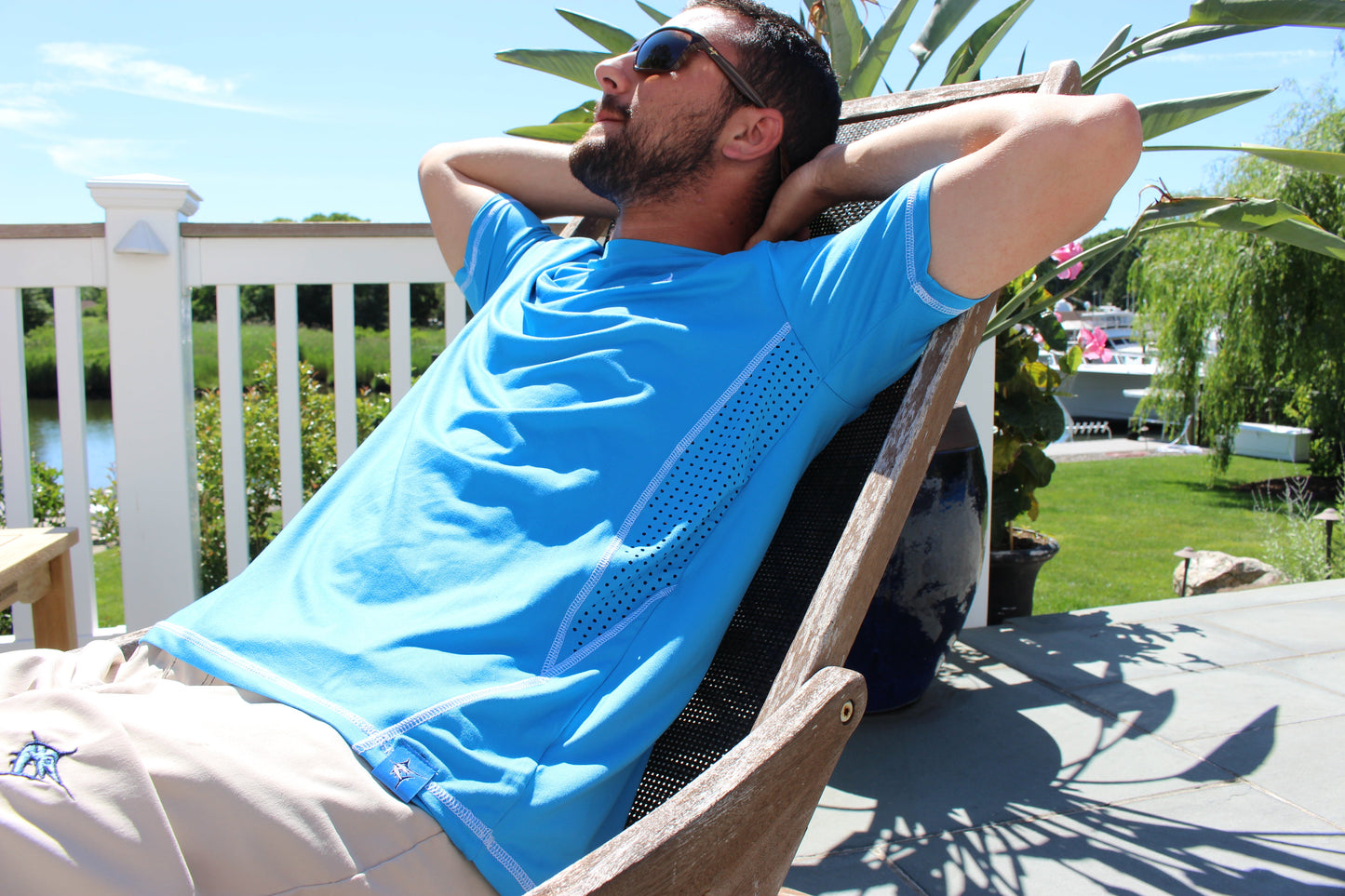 Grander Short Sleeve Performance Tee blue top with mesh panels by White Water Life worn outdoors on Tampa Home & Garden Store