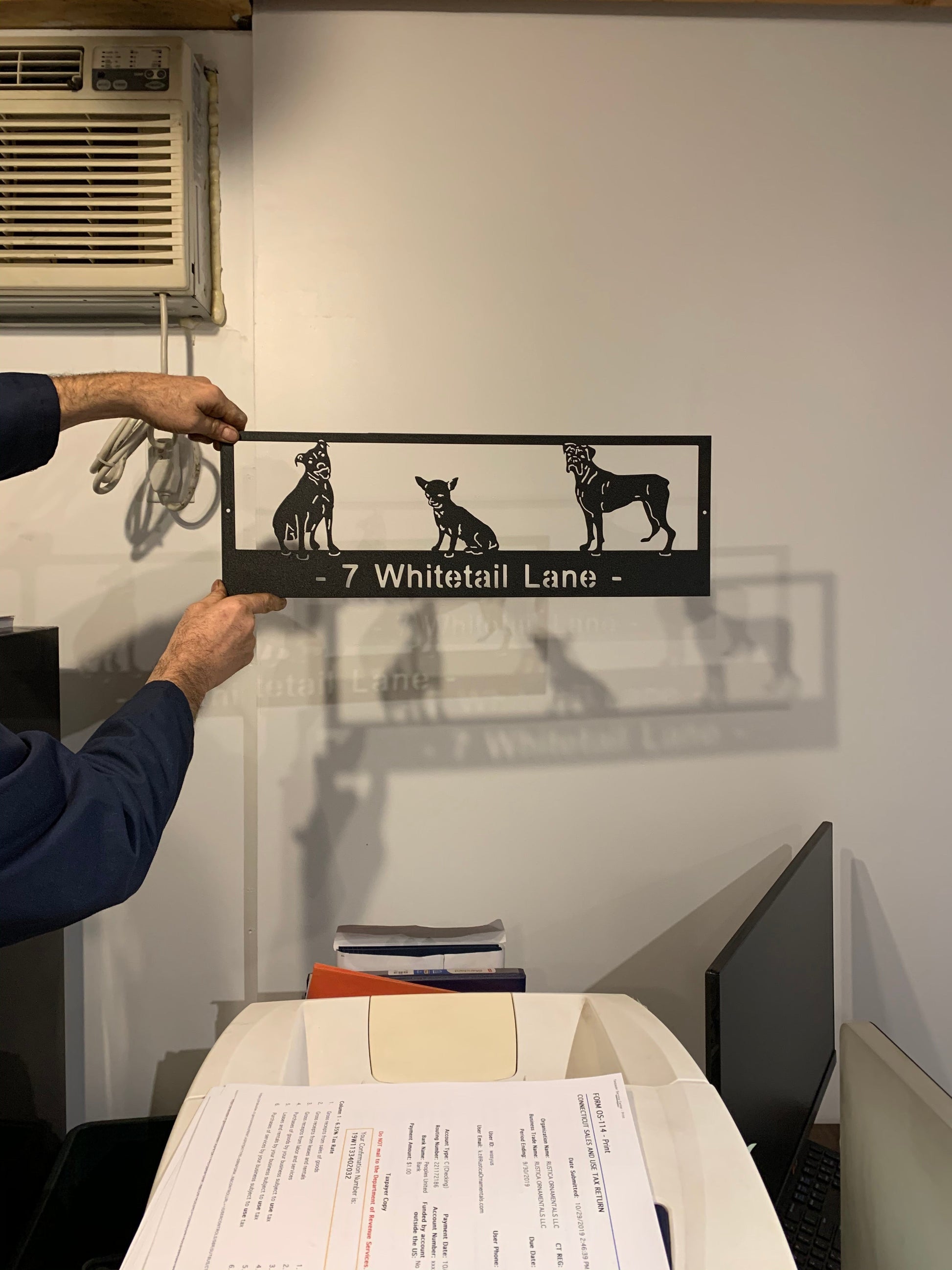 Custom metal pet sign with 3 black dog silhouettes and address 7 Whitetail Lane on Tampa Home & Garden Store