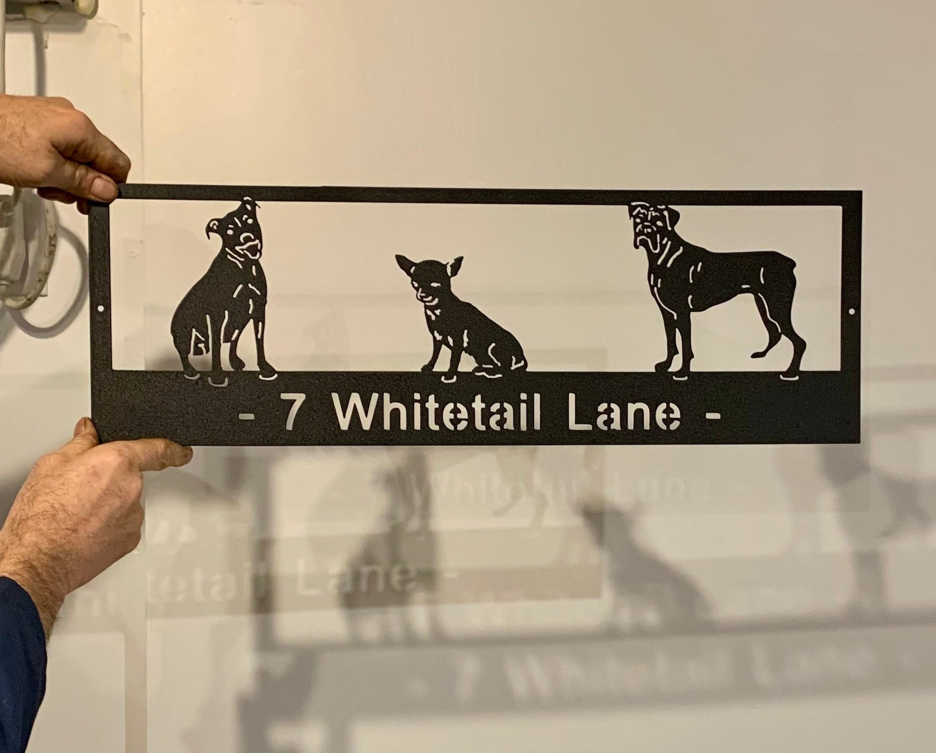 Custom metal pet sign with black frame and three white dog silhouettes, address 7 Whitetail Lane by Rustica Ornamentals on Tampa Home & Garden Store