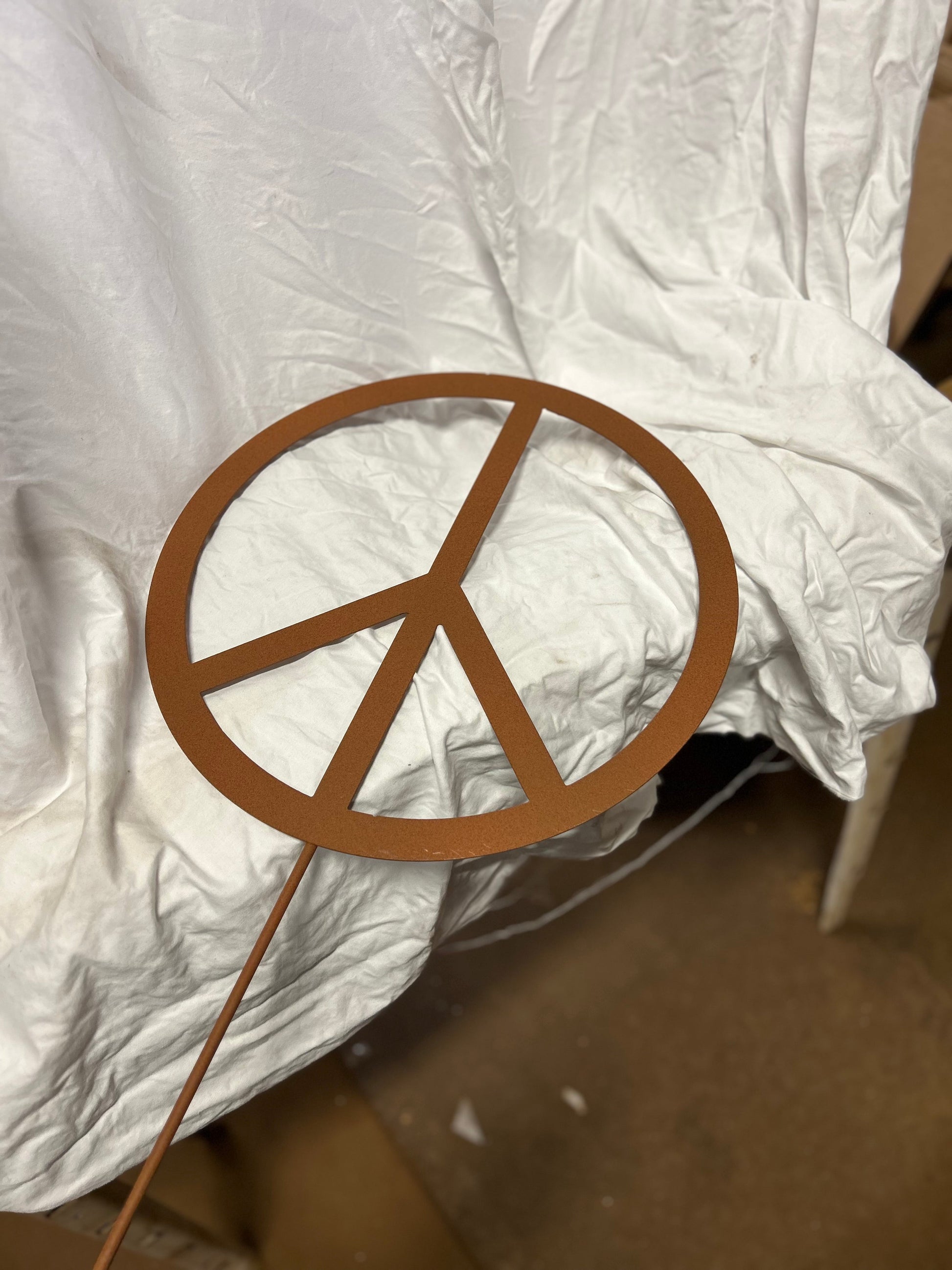 Peace sign metal lawn ornament rust-colored finish on stake by Rustica Ornamentals on Tampa Home & Garden Store