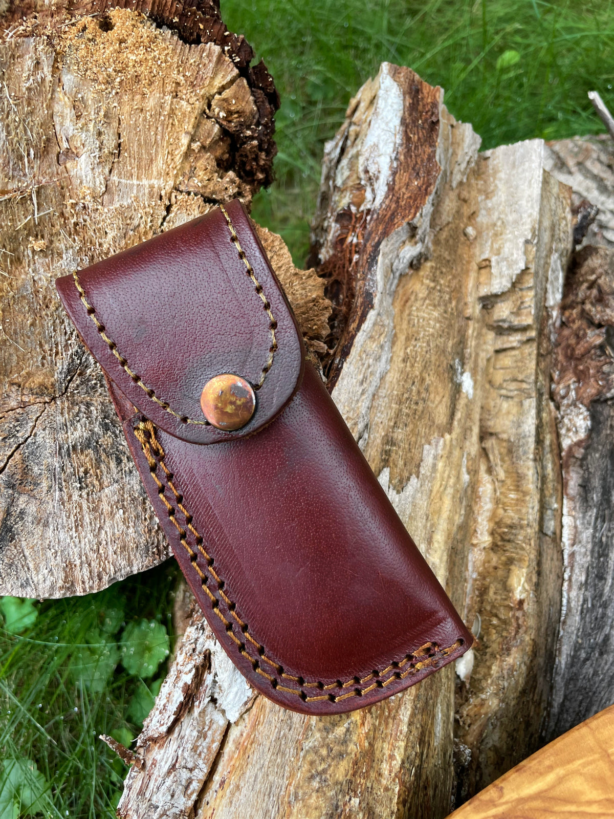 Damasucs pocket knife sheath in burgundy leather with yellow contrast stitching and a brass snap on Tampa Home & Garden Store