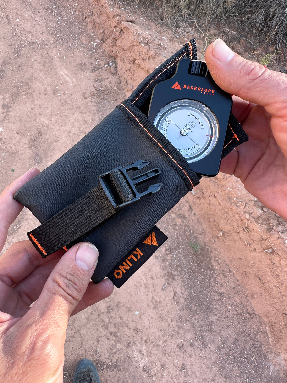 Klino Kover clinometer in black sleeve with orange stitching by Backslope Tools on Tampa Home & Garden Store