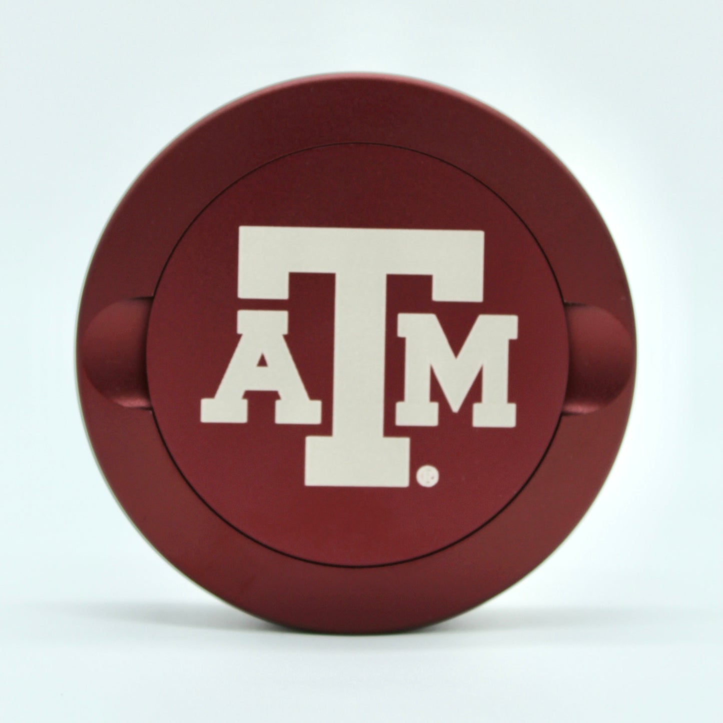 Texas A&M metal nicotine pouch can lid red circular can with white Texas A&M logo on Tampa Home & Garden Store