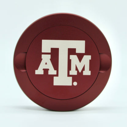 Texas A&M metal nicotine pouch can lid red circular can with white Texas A&M logo on Tampa Home & Garden Store