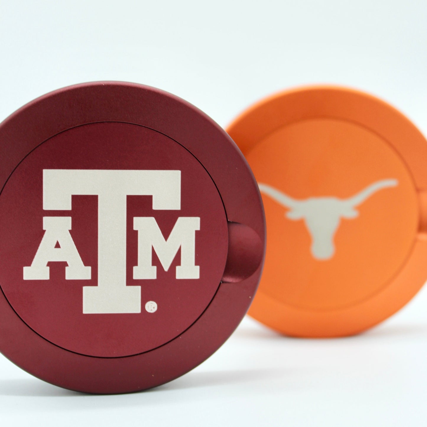Texas A&M metal nicotine pouch cans lids in maroon and orange, close-up on Tampa Home & Garden Store