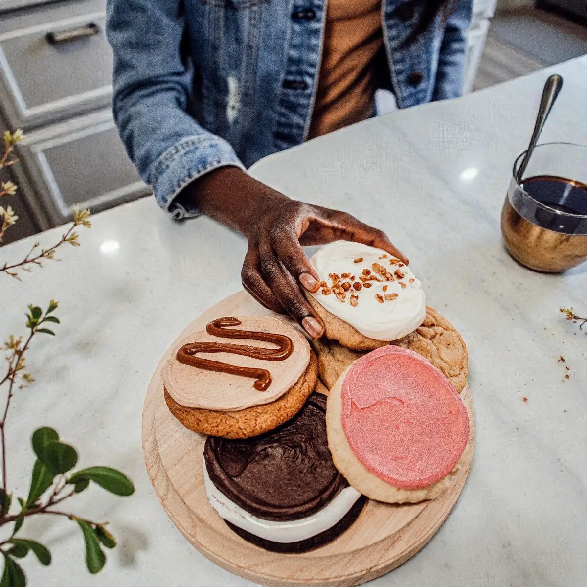 Gia Roma rustic round wood jewelry tray on pedestal with assorted cookies on marble counter on Tampa Home & Garden Store