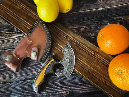 Titan Custom Alaskan Ulu style Damascus steel knife with leather sheath on dark wood surface on Tampa Home & Garden Store