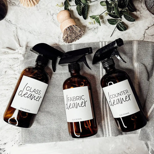 Three 16oz amber glass spray bottles by Gia Roma labeled glass, fabric, counter cleaners on Tampa Home & Garden Store