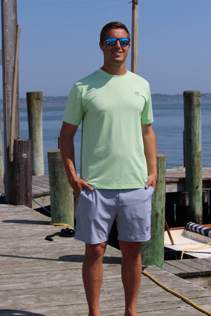 Dockside Performance Tee light green short-sleeve by White Water Life at a marina dock on Tampa Home & Garden Store