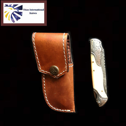 TF-005 Titan knife with brown leather sheath and engraved silver blade logo visible on Tampa Home & Garden Store