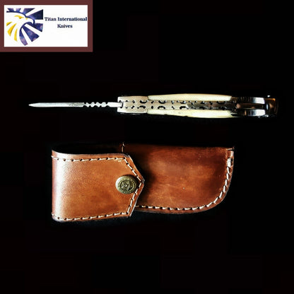 TF-005 Titan International Knives balisong with cream handles and metal frame, with leather sheath on Tampa Home & Garden Store