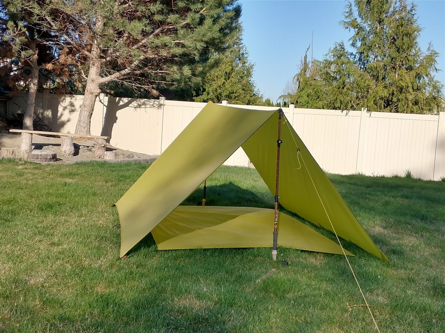 Trekker Elite Tarp Tent by River Country Gear in olive green, pitched on lawn with guy lines on Tampa Home & Garden Store
