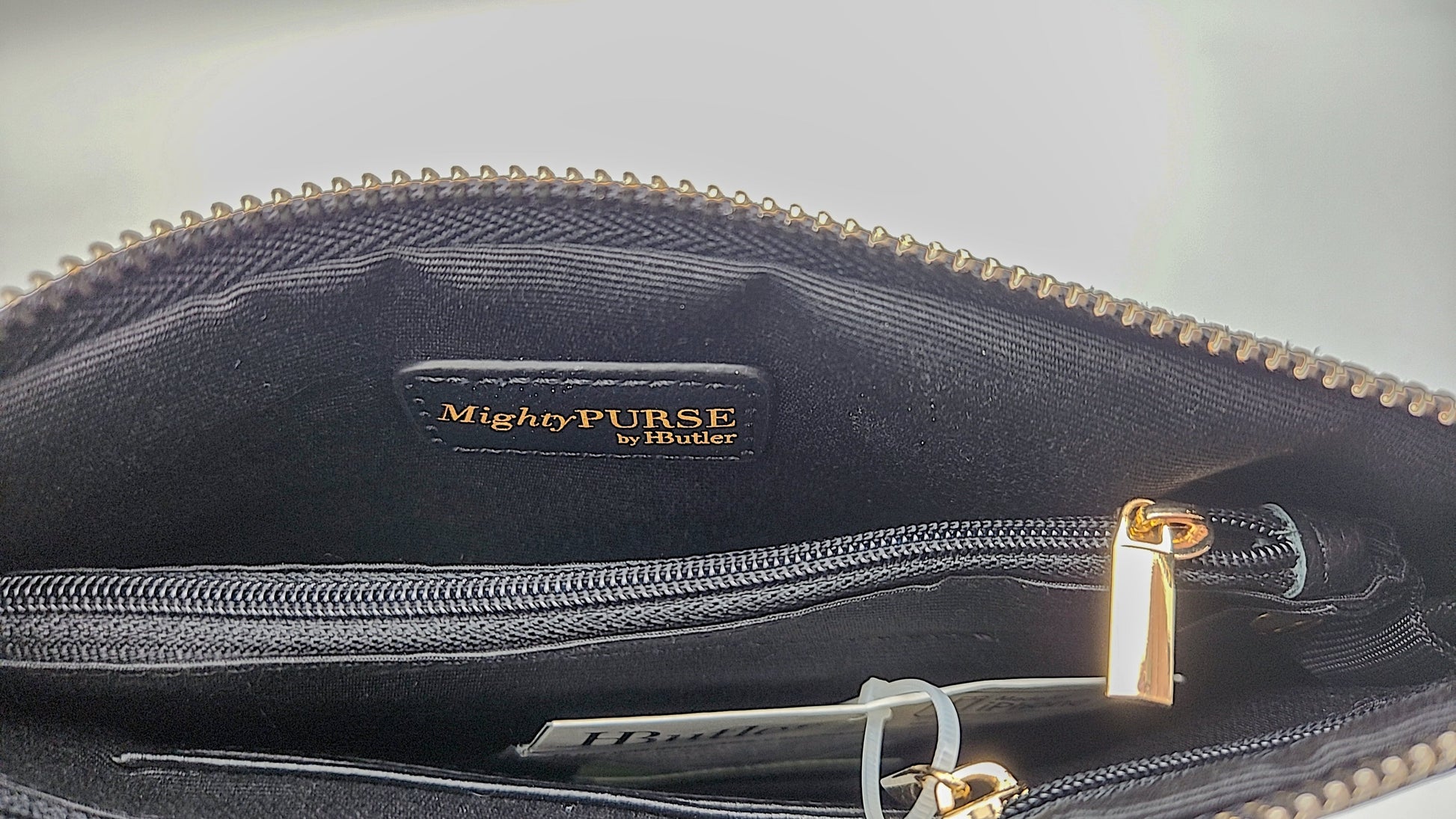 MightyPURSE black genuine leather interior label by HButler with gold zipper pull on Tampa Home & Garden Store