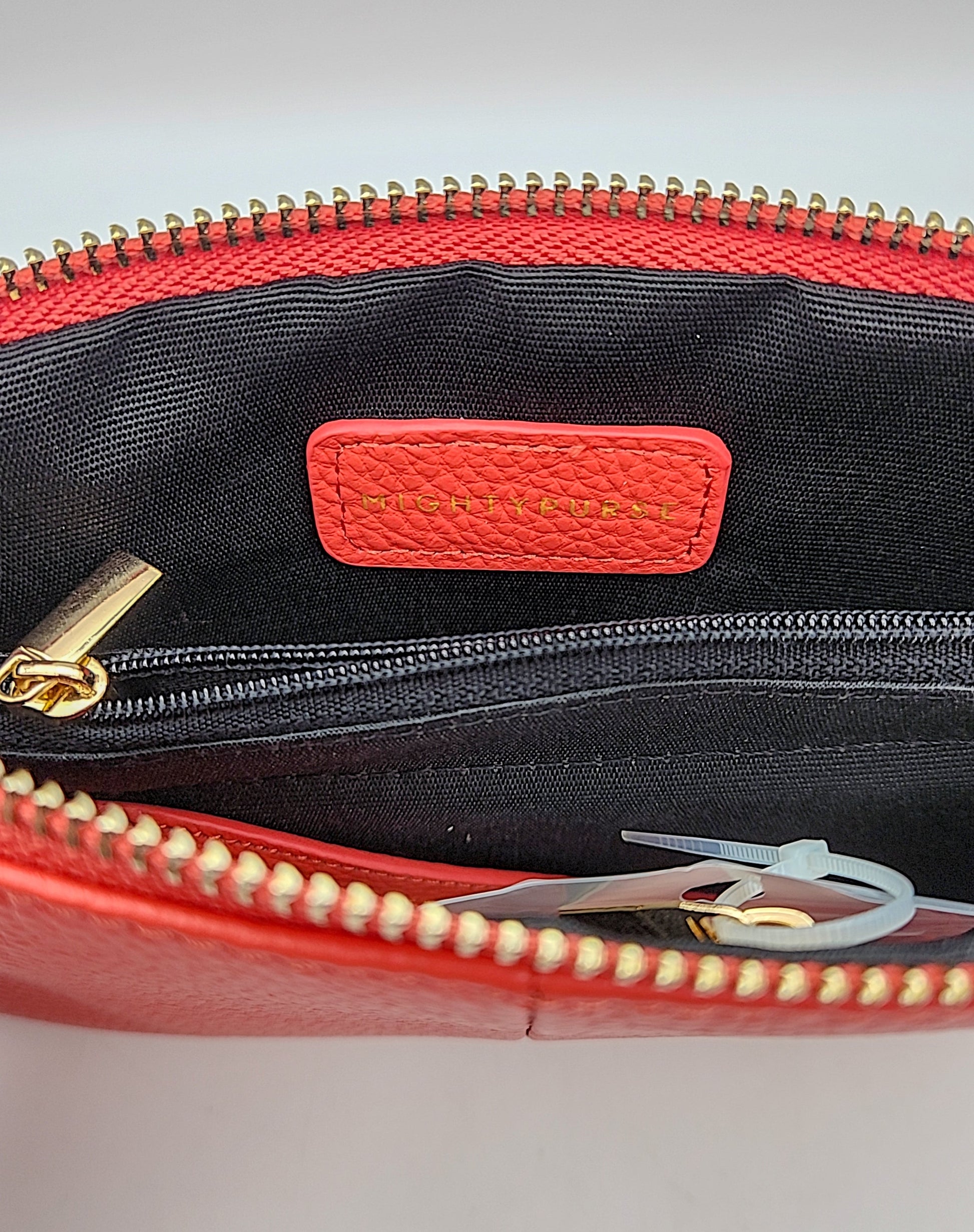 Mighty Purse red leather patch inside black fabric zip purse with gold zipper teeth on Tampa Home & Garden Store