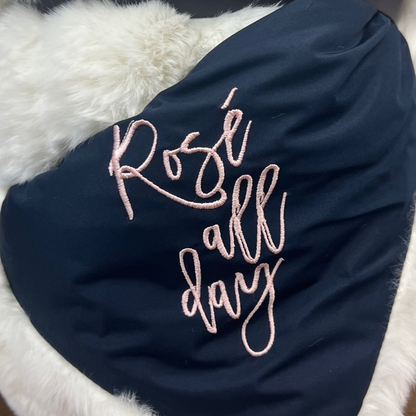 Rosé All Day navy lap blanket with pink embroidery by Pretty Rugged on white faux fur backdrop on Tampa Home & Garden Store