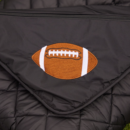 Football patch on black quilted puffer blanket with zipper on Tampa Home & Garden Store