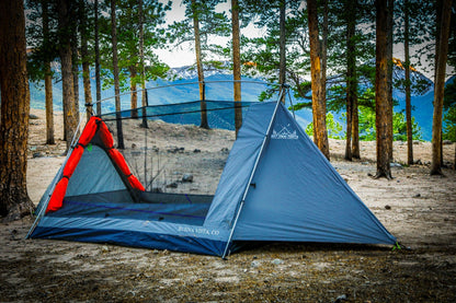 Sky View Duo Tent gray body with orange entrance in a pine forest by Sky View Tents on Tampa Home & Garden Store