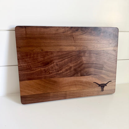 Texas Longhorns walnut cutting board with rounded corners and Longhorn logo on Tampa Home & Garden Store