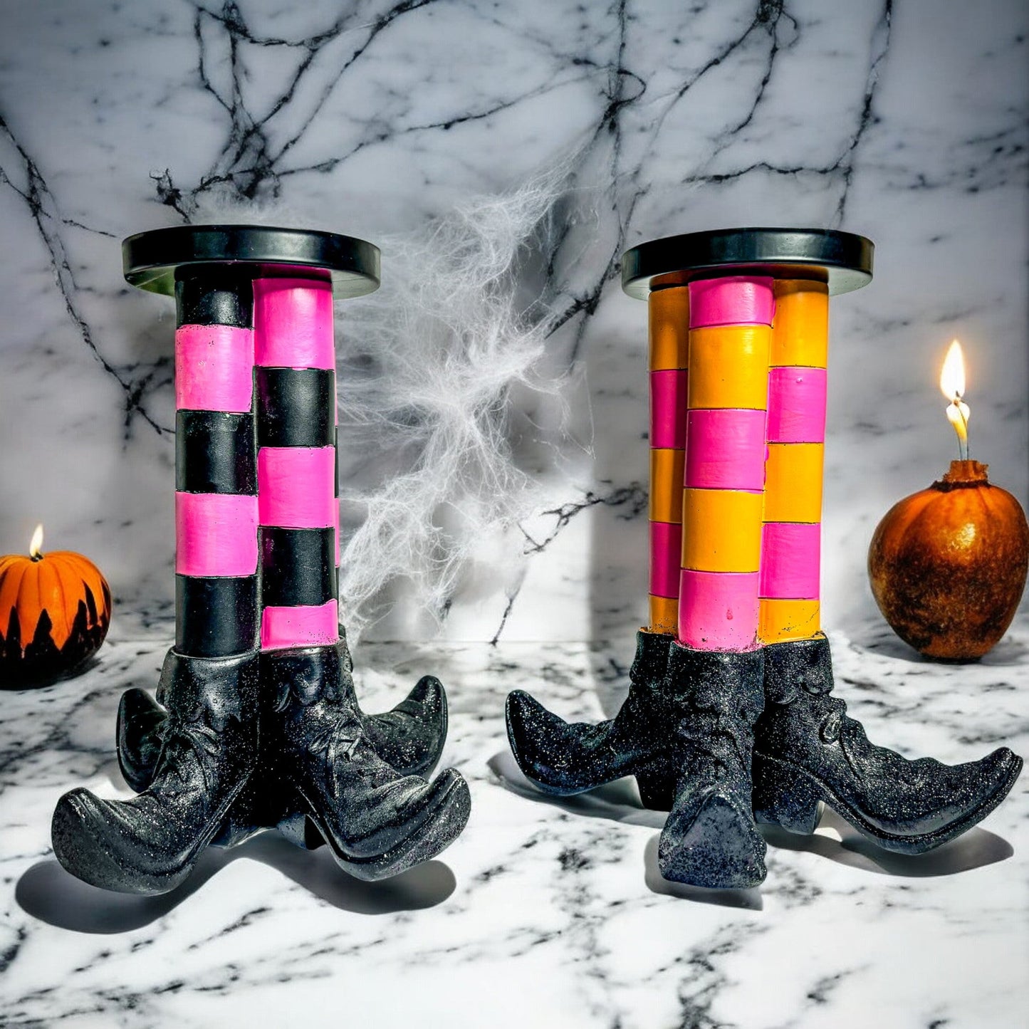 Two Wicked Witch Candle Holders with pink and black striped columns on black boot bases on Tampa Home & Garden Store